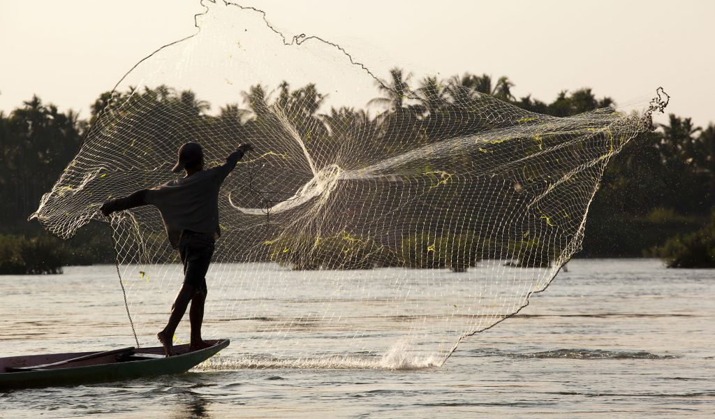 A fisherman throws his net