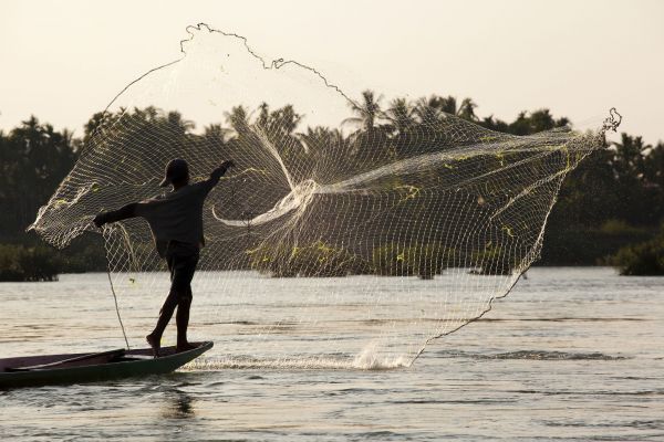 A fisherman throws his net