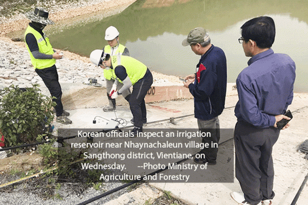 Korean officials inspect an irrigation reservoir